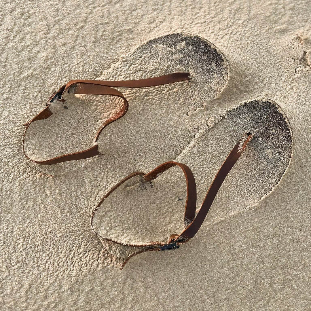 ZuZu Flex barefoot performance sandals with a breathable canvas footbed and replaceable recycled straps, designed for natural movement and all-day comfort. Covered in light sand.