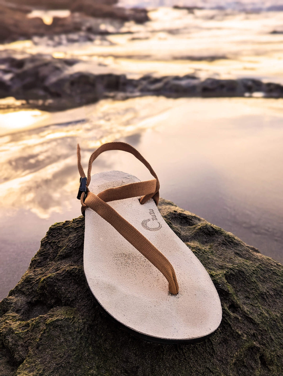 ZuZu Dune barefoot sandals with a premium water-repellent leather footbed and replaceable recycled bronze colored straps, crafted for water eco-friendly barefoot performance.